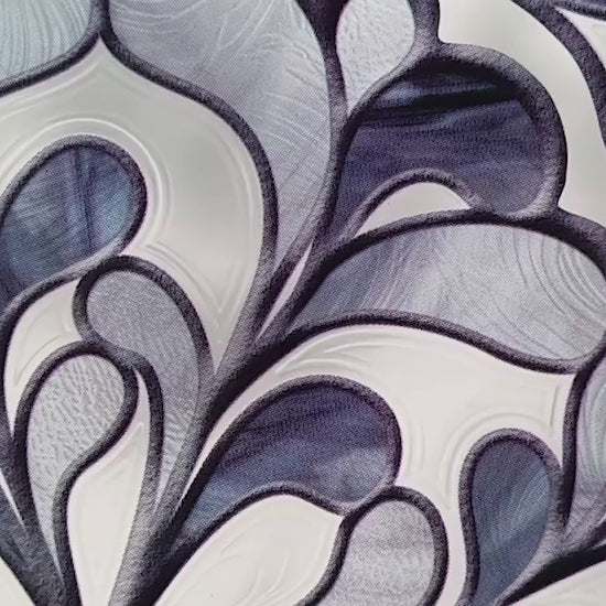 Video moving over close-up of a decorative accent in shades of blue that has a visual effect of textured glass.